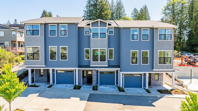 26632 NE 143rd Pl, Duvall, WA 98019 - townhome / multi-family property featuring a garage, driveway, and stone siding
