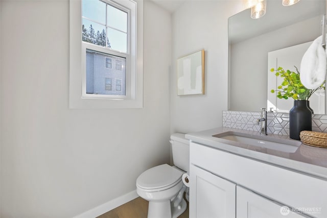 26632 NE 143rd Pl, Duvall, WA 98019 - bathroom with toilet, vanity, baseboards, wood finished floors, and backsplash