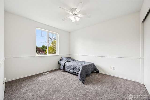 bedroom with carpet floors, baseboards, a ceiling fan, and visible vents