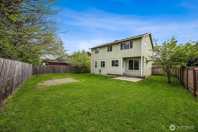 back of house featuring a lawn, a patio, and a fenced backyard