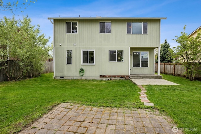 rear view of property with a patio, a fenced backyard, and a yard