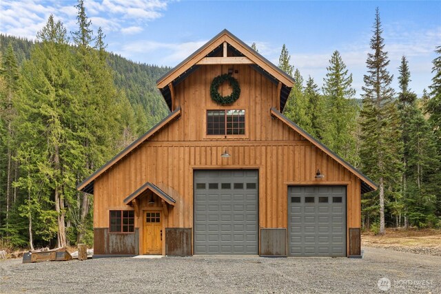 detached garage with a forest view