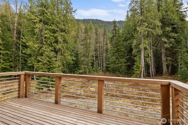 wooden deck featuring a wooded view