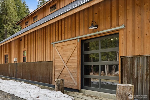 view of side of home with an outdoor structure and metal roof