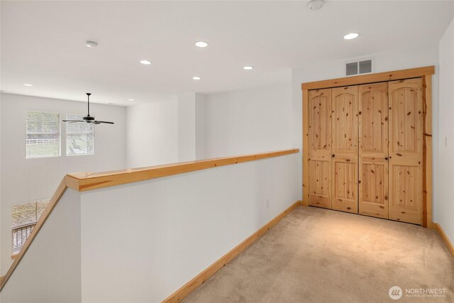 carpeted empty room featuring baseboards, a ceiling fan, recessed lighting, and visible vents