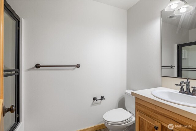 bathroom featuring toilet, visible vents, and vanity