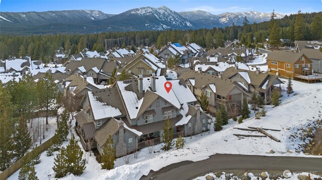 birds eye view of property featuring a forest view, a residential view, and a mountain view