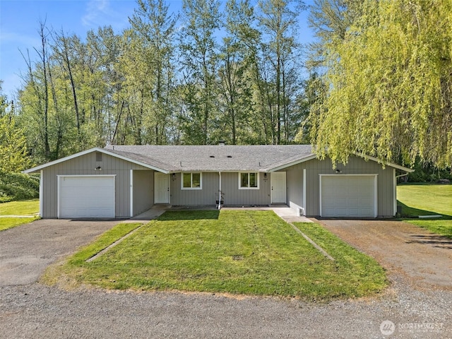 ranch-style house featuring a shingled roof, an attached garage, a front lawn, and aphalt driveway