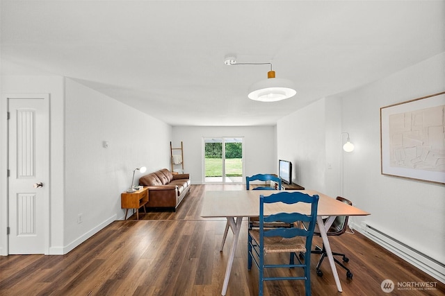dining area with baseboards, wood finished floors, and a baseboard radiator