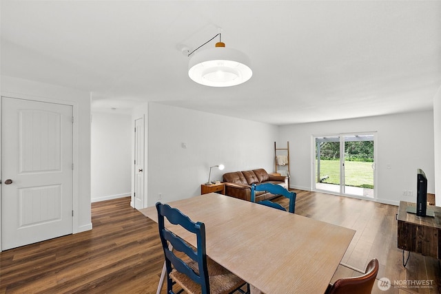 dining room featuring baseboards and wood finished floors
