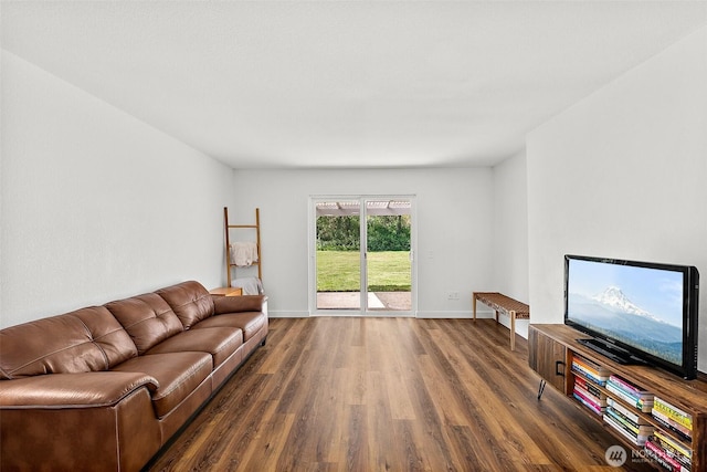 living area featuring baseboards and wood finished floors