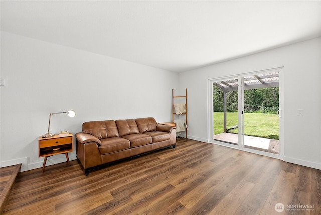 living room featuring baseboards and dark wood-style flooring