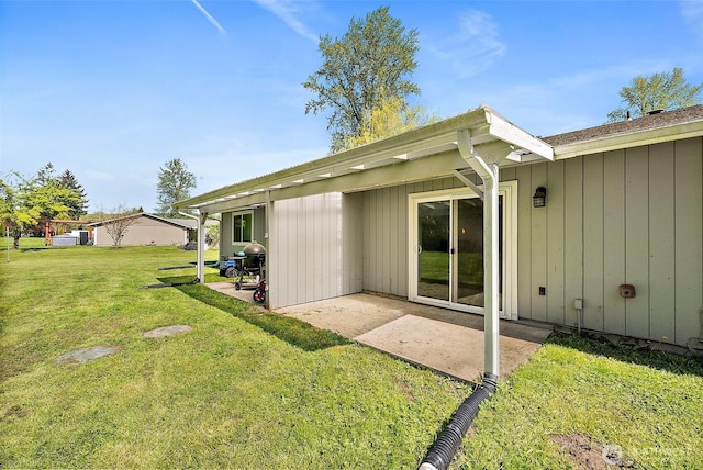 rear view of house with a lawn and a patio area