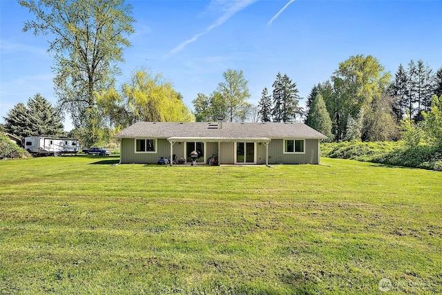 view of front of home with a patio and a front yard