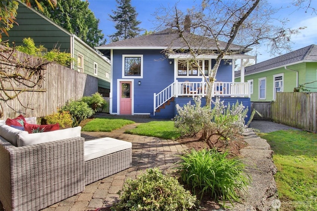 back of house featuring fence private yard, a patio area, stairway, and a porch