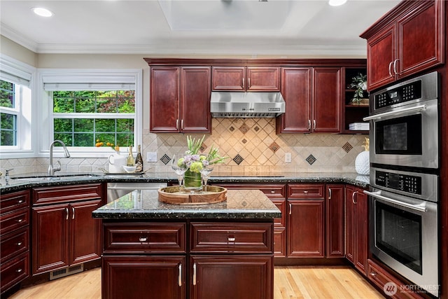 1823 Richards Rd, Bellevue, WA 98005 - kitchen with reddish brown cabinets, a sink, stainless steel double oven, and under cabinet range hood