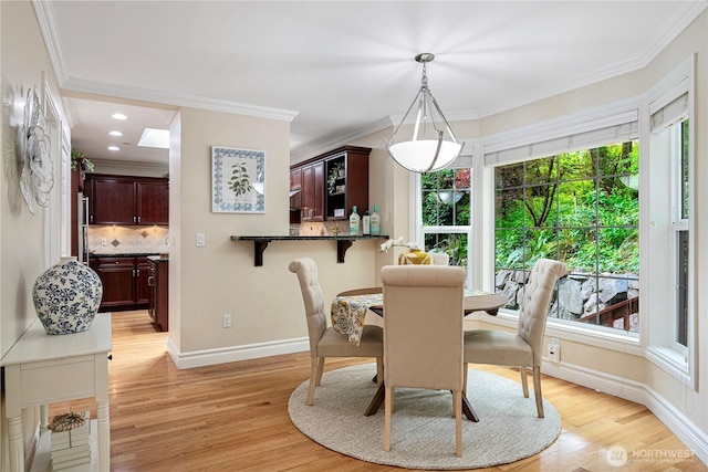 1823 Richards Rd, Bellevue, WA 98005 - dining room featuring a healthy amount of sunlight, baseboards, crown molding, and light wood-type flooring
