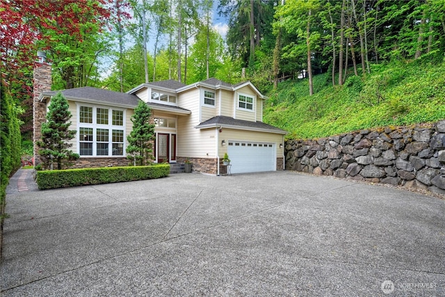 1823 Richards Rd, Bellevue, WA 98005 - view of front facade featuring a chimney, a garage, stone siding, and concrete driveway