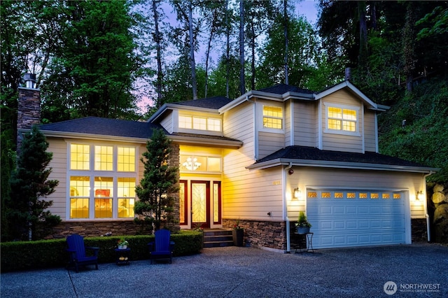 1823 Richards Rd, Bellevue, WA 98005 - traditional-style home featuring an attached garage, a chimney, driveway, and stone siding