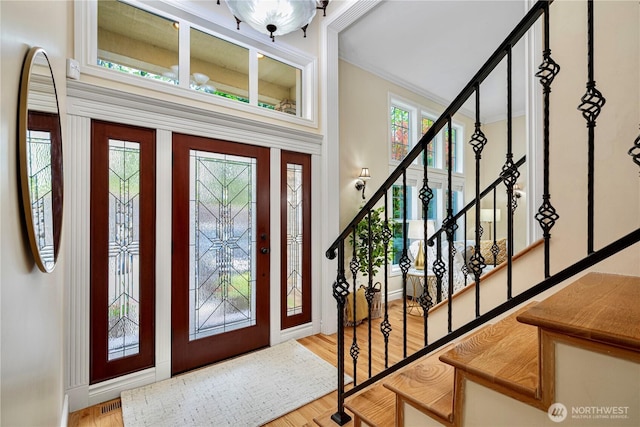1823 Richards Rd, Bellevue, WA 98005 - foyer entrance with baseboards, wood finished floors, visible vents, ornamental molding, and stairway