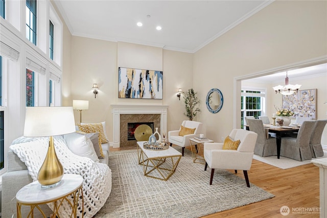 1823 Richards Rd, Bellevue, WA 98005 - living room featuring an inviting chandelier, a high end fireplace, wood finished floors, and ornamental molding