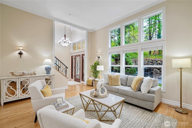 1823 Richards Rd, Bellevue, WA 98005 - living area featuring ornamental molding, wood finished floors, baseboards, stairway, and a chandelier