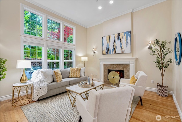 1823 Richards Rd, Bellevue, WA 98005 - living area with ornamental molding, baseboards, light wood-style floors, recessed lighting, and a high end fireplace