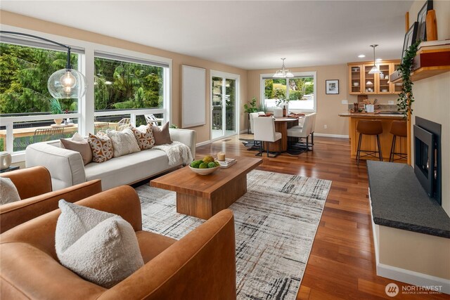 living room featuring baseboards, recessed lighting, and wood finished floors