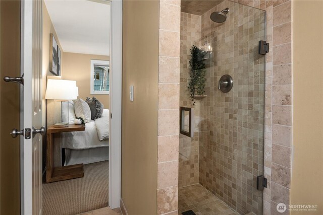ensuite bathroom featuring a shower stall and ensuite bathroom