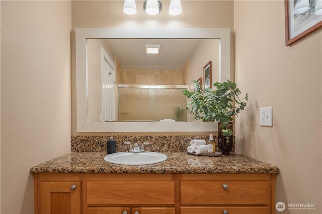 bathroom featuring vanity and a stall shower