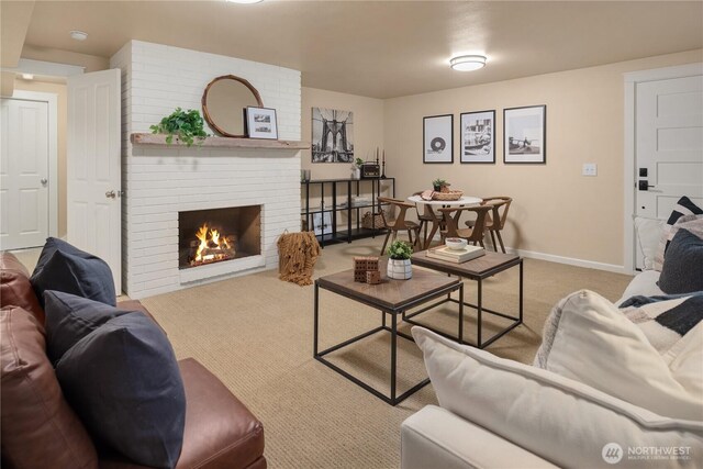 living area with a fireplace, baseboards, and carpet