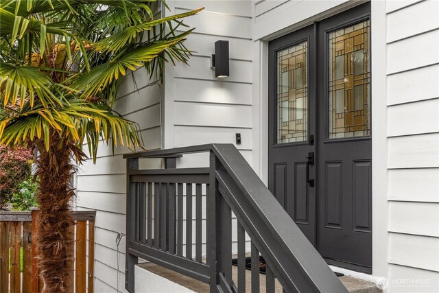doorway to property featuring fence