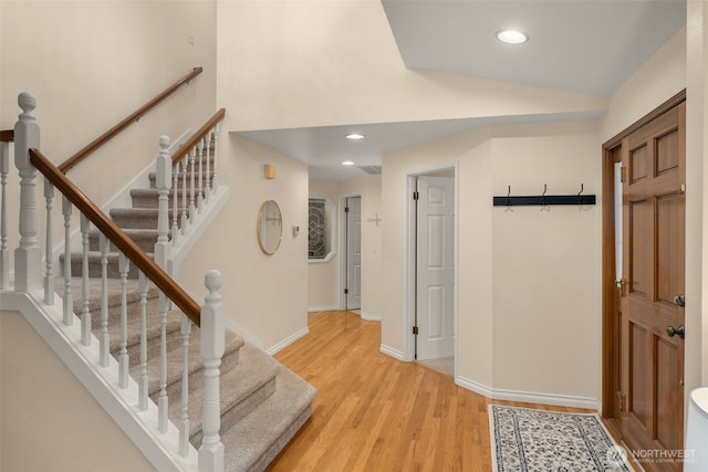foyer with baseboards, recessed lighting, light wood-style flooring, and stairway