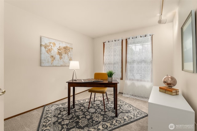 carpeted office with baseboards