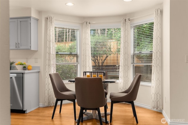 dining room featuring recessed lighting, baseboards, a wealth of natural light, and light wood-style flooring