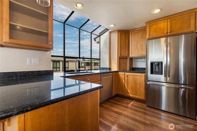 1113 5th Ave S Unit 301, Edmonds, WA 98020 - kitchen with appliances with stainless steel finishes, a sink, floor to ceiling windows, brown cabinetry, and dark wood-style floors