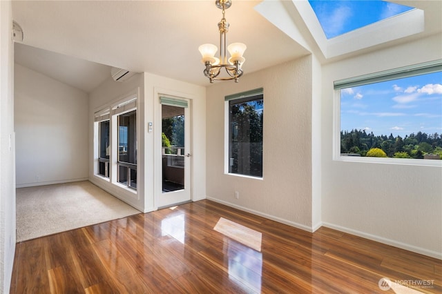 1113 5th Ave S Unit 301, Edmonds, WA 98020 - spare room featuring wood finished floors, a chandelier, baseboards, and vaulted ceiling