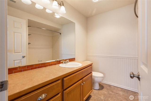 1113 5th Ave S Unit 301, Edmonds, WA 98020 - full bathroom with vanity, toilet, a wainscoted wall, tile patterned floors, and a shower