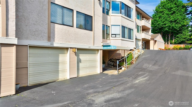 1113 5th Ave S Unit 301, Edmonds, WA 98020 - view of building exterior with an attached garage and driveway