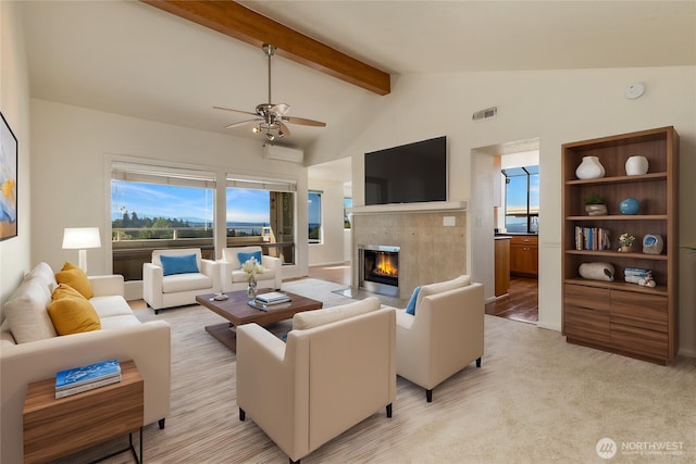 1113 5th Ave S Unit 301, Edmonds, WA 98020 - living room with a ceiling fan, a tile fireplace, plenty of natural light, and light carpet