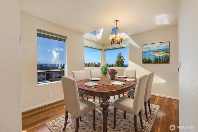 1113 5th Ave S Unit 301, Edmonds, WA 98020 - dining room with wood finished floors, baseboards, a chandelier, and a skylight