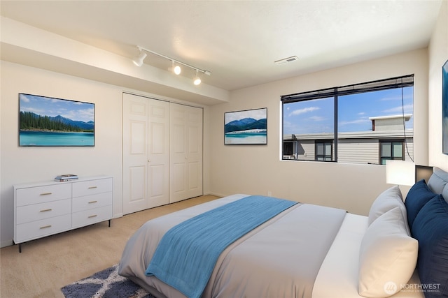 1113 5th Ave S Unit 301, Edmonds, WA 98020 - bedroom with rail lighting, light carpet, and a closet