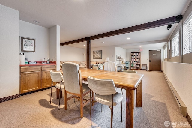 1113 5th Ave S Unit 301, Edmonds, WA 98020 - dining room with light colored carpet, beam ceiling, baseboard heating, recessed lighting, and baseboards
