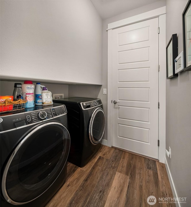 clothes washing area featuring independent washer and dryer, laundry area, dark wood-style floors, and baseboards