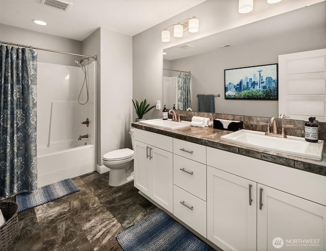 bathroom featuring a sink, toilet, double vanity, and visible vents
