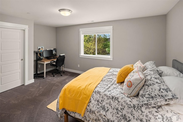 bedroom featuring baseboards, dark carpet, and visible vents