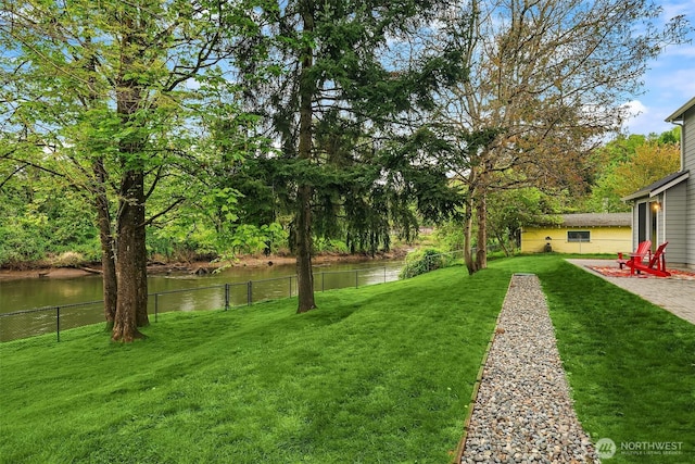 view of yard featuring fence and a water view