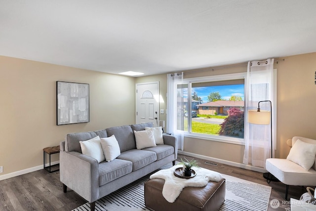 living room with wood finished floors and baseboards