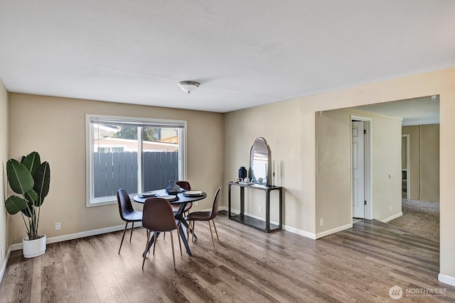 dining room featuring wood finished floors and baseboards