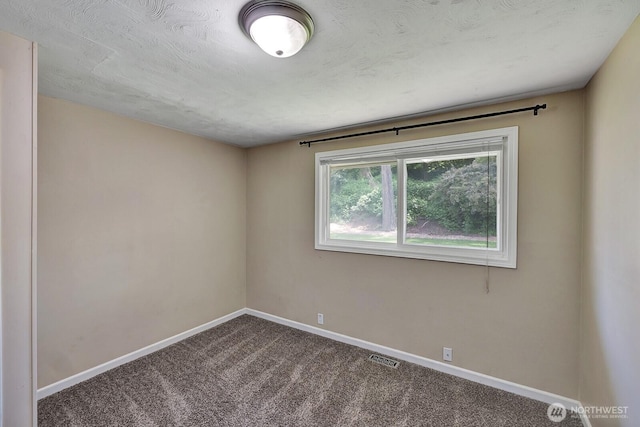 spare room featuring baseboards and carpet floors